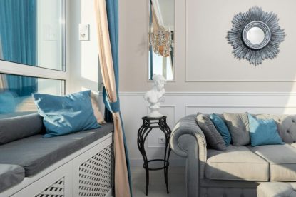 Stylish living room interior with cushions and decor, inspiring homeownership.